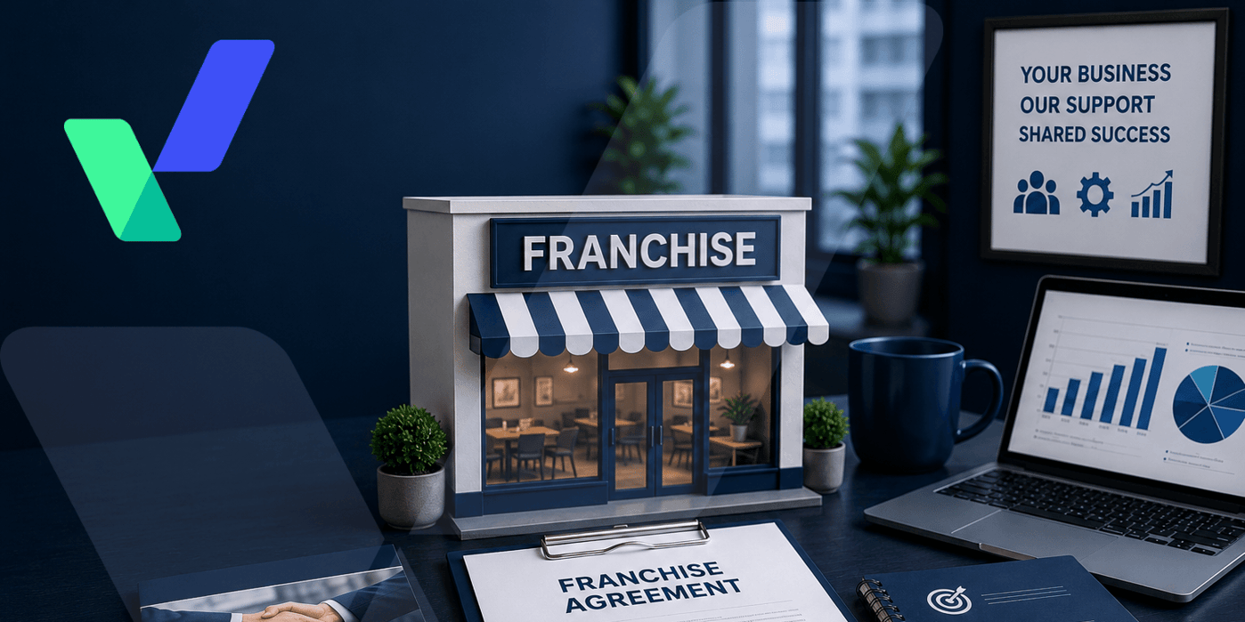 Professional franchise business workspace featuring a miniature branded storefront, franchise agreement, planning notebook, laptop with growth charts, and partnership imagery in a modern blue-toned office setting.